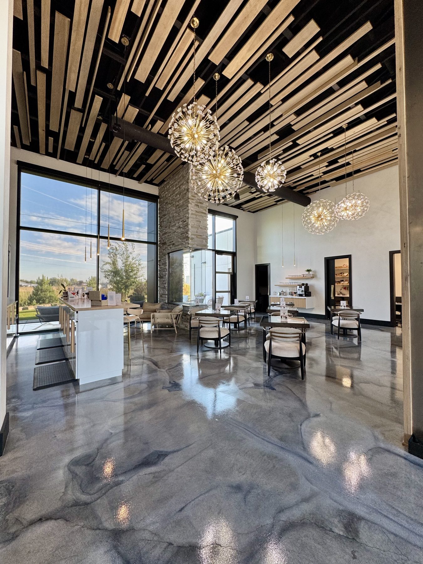 Double-height corporate lobby with polished concrete floors and a glass curtain wall