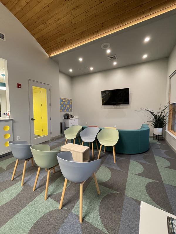 Waiting room with lounge chairs under a timber ceiling