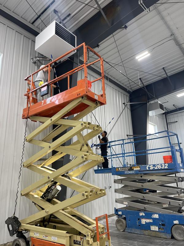 Crew on scissor lifts detailing high steelwork