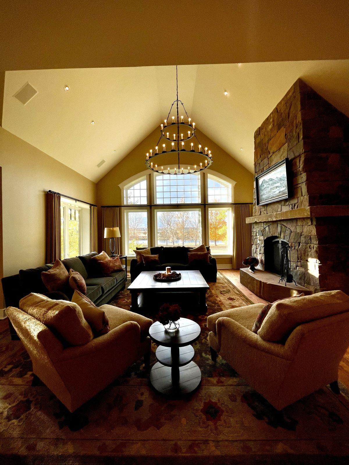 Living room with a stone fireplace, guest-ready